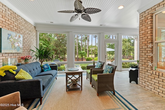 sunroom featuring ceiling fan