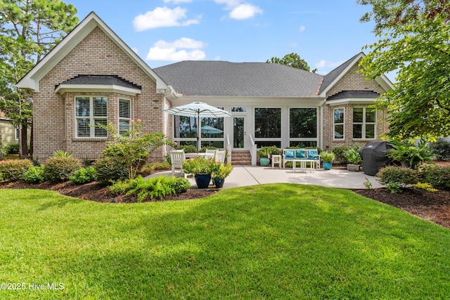 back of property featuring a yard and a patio area