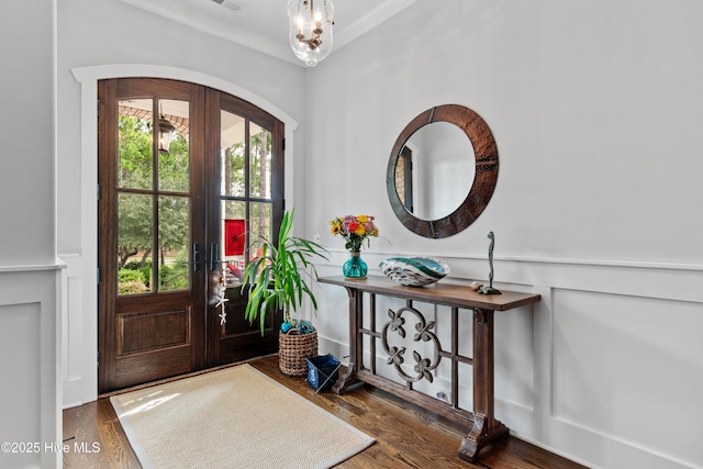 entryway featuring french doors, dark hardwood / wood-style flooring, and ornamental molding