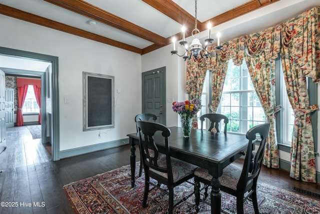 dining space with beamed ceiling, dark hardwood / wood-style floors, and a chandelier