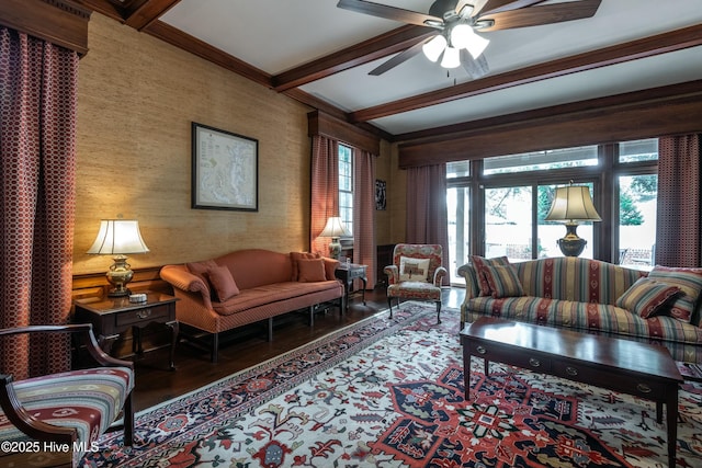 living room featuring ceiling fan, wood-type flooring, and beamed ceiling