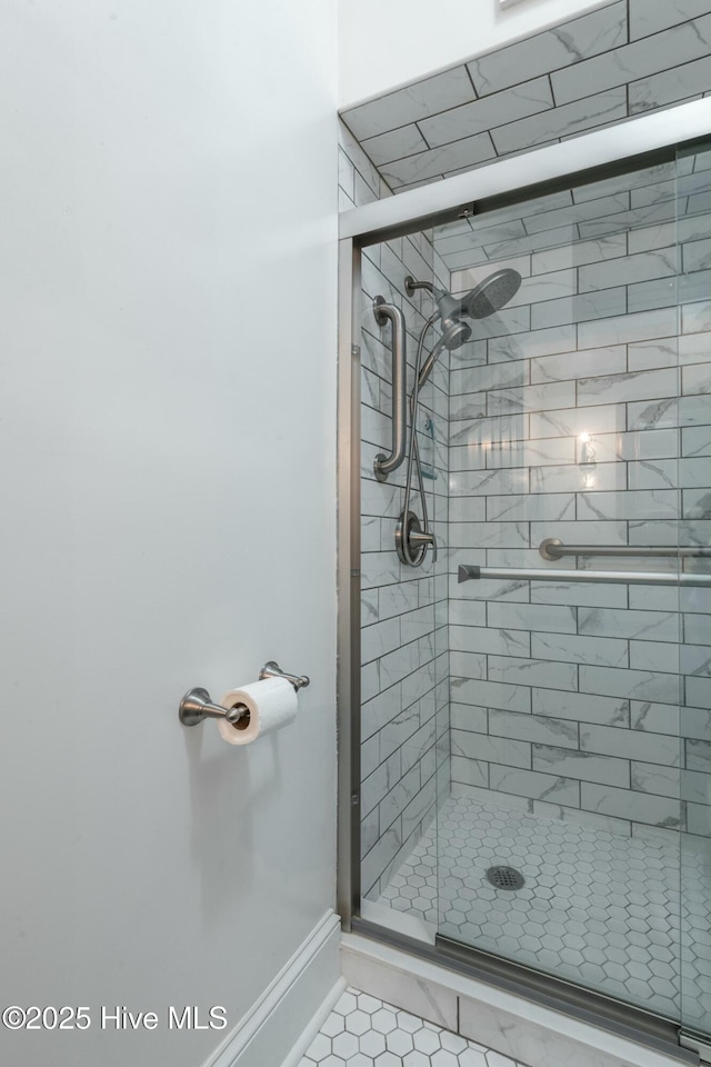 bathroom with a shower with door