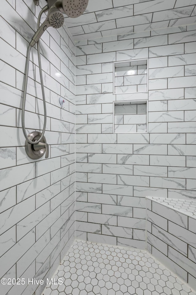 bathroom with a tile shower