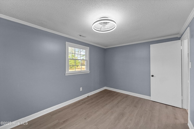 unfurnished room featuring crown molding, light hardwood / wood-style floors, and a textured ceiling