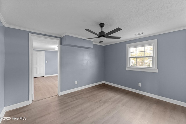 unfurnished room featuring ornamental molding, a textured ceiling, and light wood-type flooring