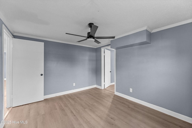 interior space featuring ceiling fan, ornamental molding, light hardwood / wood-style floors, and a textured ceiling