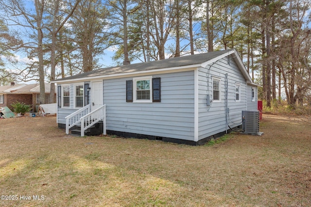 view of front of property with a front yard and central AC unit