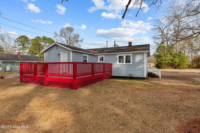 back of property featuring a yard and a deck