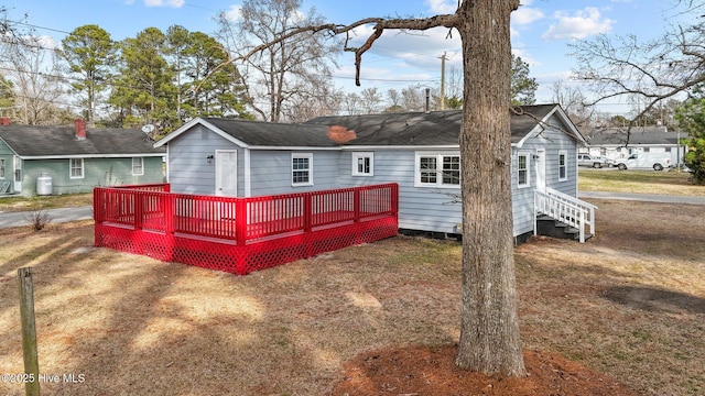 rear view of house with a yard and a deck