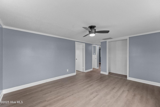 unfurnished room with ornamental molding, ceiling fan, a textured ceiling, and light hardwood / wood-style floors