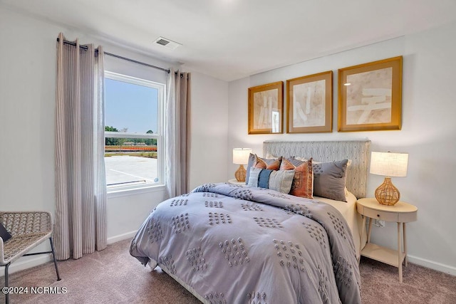 bedroom featuring carpet floors, visible vents, and baseboards