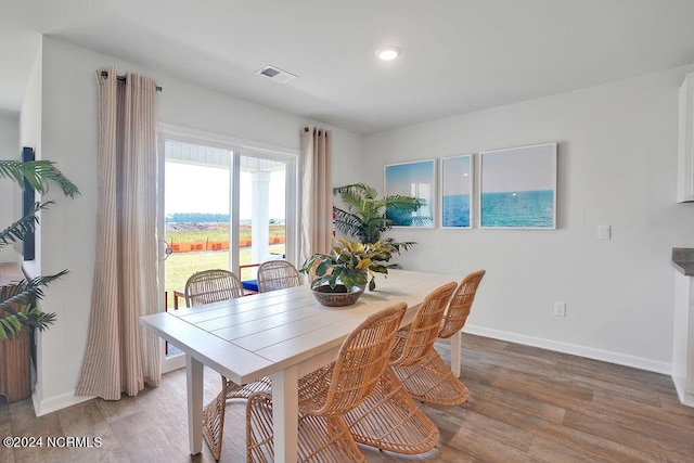 dining space featuring recessed lighting, wood finished floors, visible vents, and baseboards