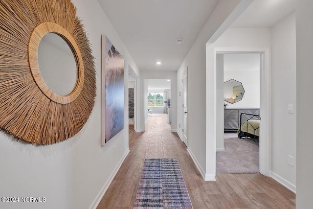 corridor with light hardwood / wood-style flooring