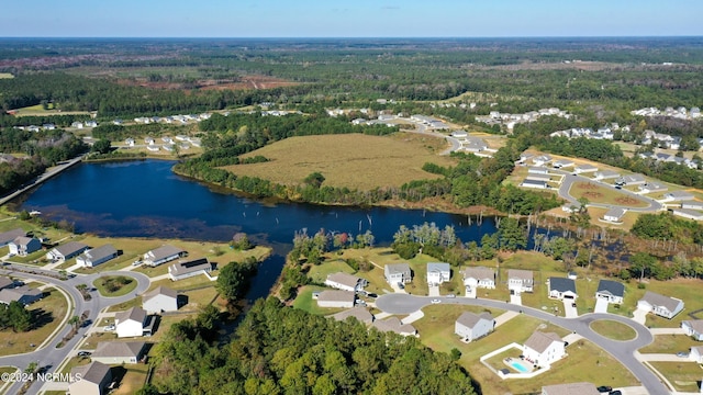 birds eye view of property featuring a residential view, a water view, and a forest view