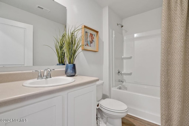 full bath featuring shower / tub combo, visible vents, toilet, wood finished floors, and vanity