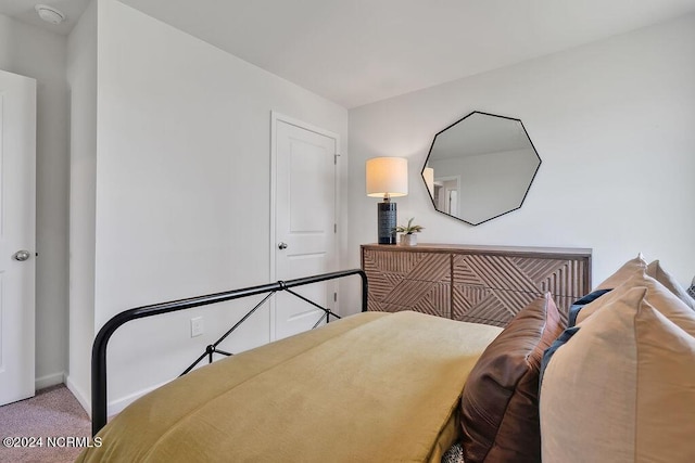 bedroom with carpet floors and baseboards