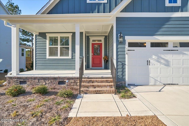 entrance to property with a garage and covered porch