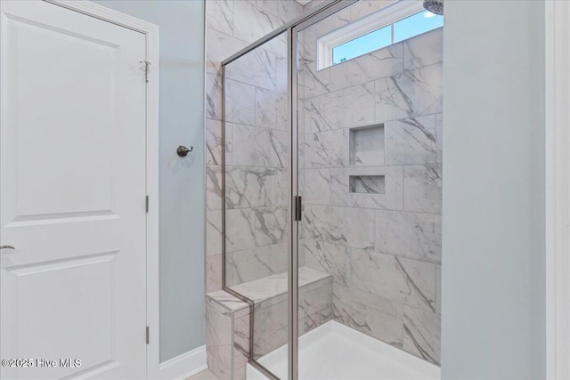 bathroom with a shower with shower door