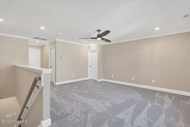 carpeted spare room with ceiling fan and ornamental molding