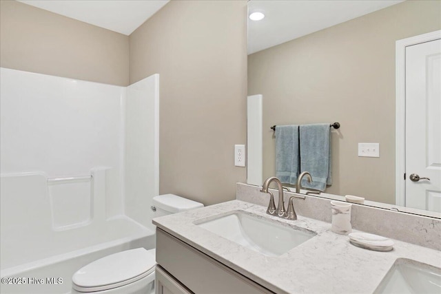 full bathroom with vanity, toilet, and washtub / shower combination