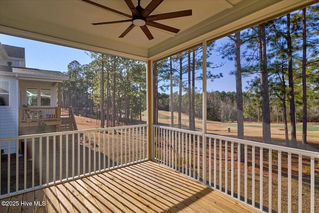 unfurnished sunroom with ceiling fan