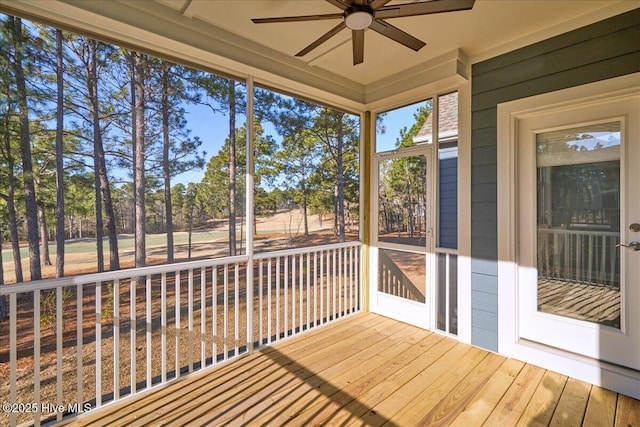 unfurnished sunroom with ceiling fan