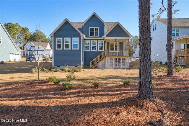 rear view of property featuring ceiling fan and a porch