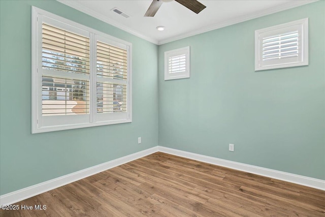 empty room with hardwood / wood-style flooring, ceiling fan, and crown molding