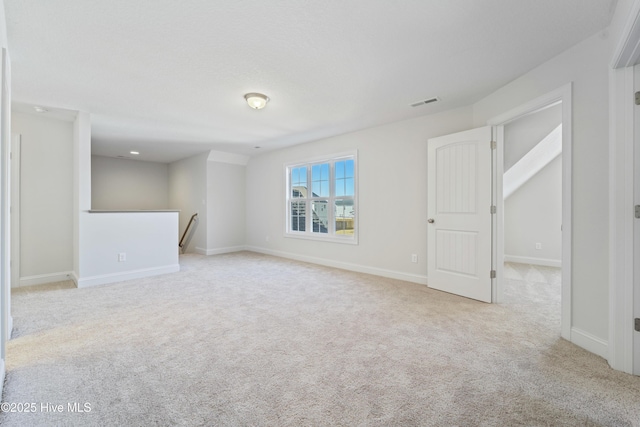 empty room featuring light colored carpet