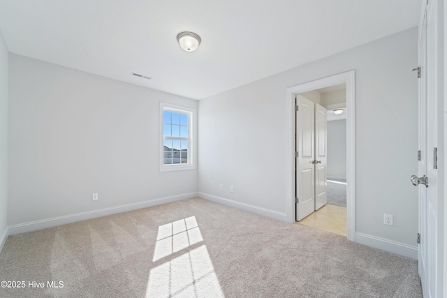 unfurnished bedroom with light colored carpet