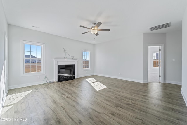 unfurnished living room featuring hardwood / wood-style flooring and ceiling fan