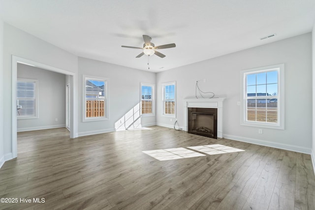 unfurnished living room featuring ceiling fan and wood-type flooring