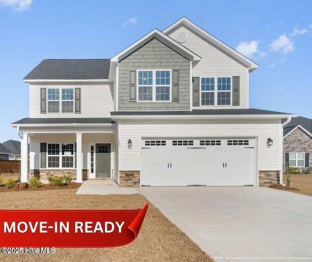 craftsman house featuring covered porch and a garage