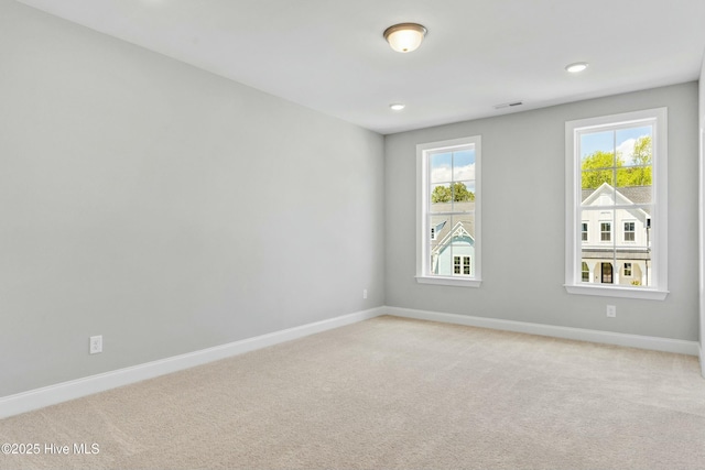 unfurnished room with plenty of natural light and light colored carpet