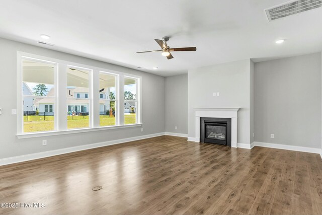 unfurnished living room featuring sink, dark hardwood / wood-style flooring, and ceiling fan