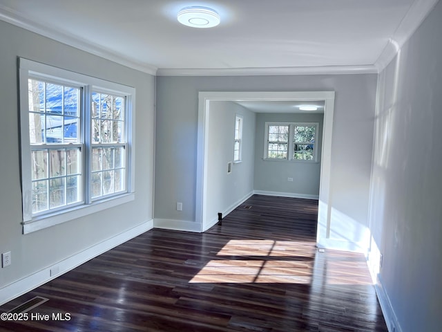 unfurnished room with ornamental molding and dark hardwood / wood-style flooring