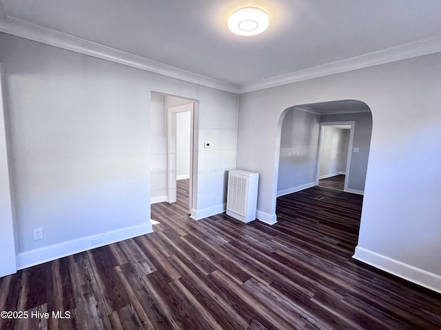 spare room with dark hardwood / wood-style flooring and ornamental molding