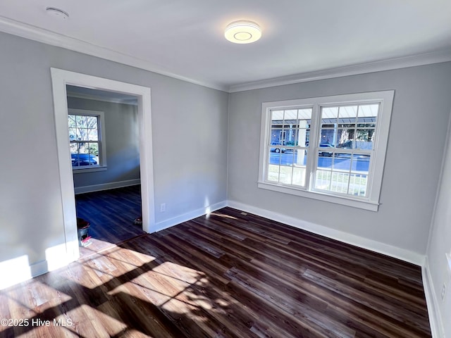 unfurnished room with a healthy amount of sunlight, dark hardwood / wood-style flooring, and crown molding