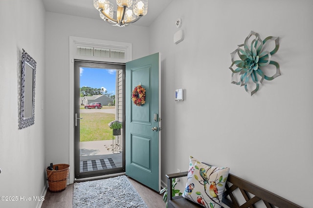 entrance foyer featuring light hardwood / wood-style floors and a notable chandelier