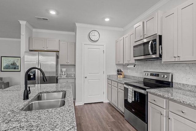 kitchen featuring crown molding, sink, light stone countertops, and appliances with stainless steel finishes