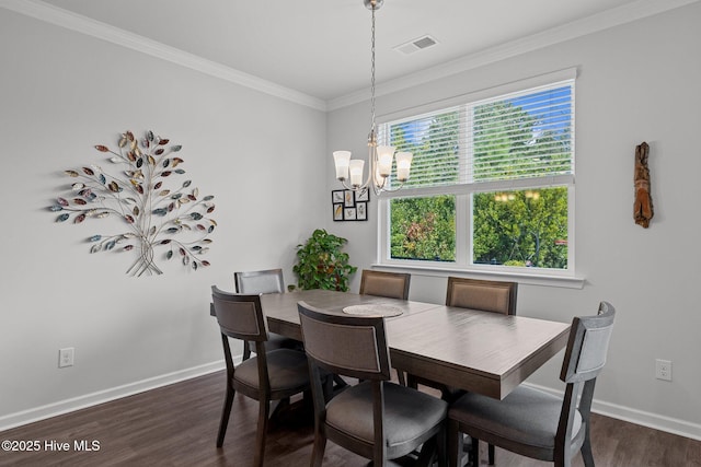 dining room with plenty of natural light, ornamental molding, dark hardwood / wood-style floors, and an inviting chandelier