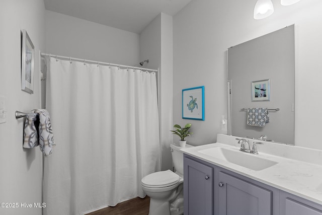 bathroom featuring a shower with curtain, hardwood / wood-style floors, vanity, and toilet