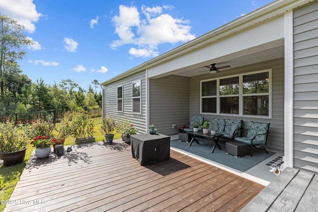 deck with outdoor lounge area and ceiling fan