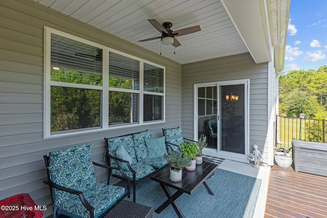 wooden terrace featuring an outdoor living space and ceiling fan