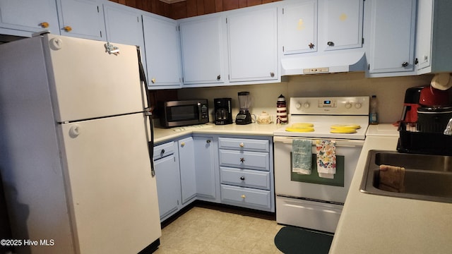 kitchen with white refrigerator, range with electric cooktop, and sink