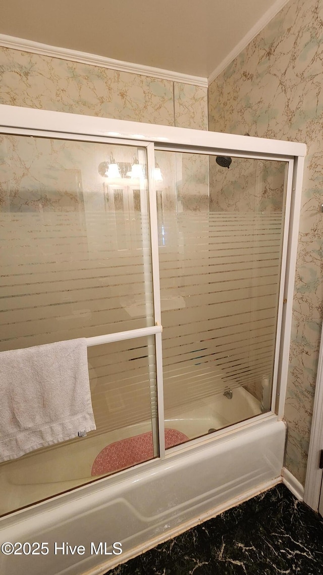 bathroom featuring bath / shower combo with glass door