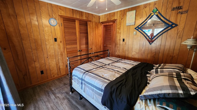 bedroom with ceiling fan, ornamental molding, and wooden walls