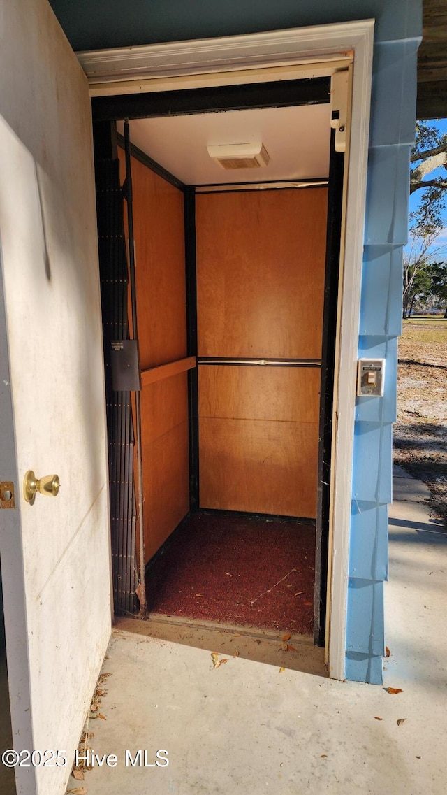 hall with concrete flooring