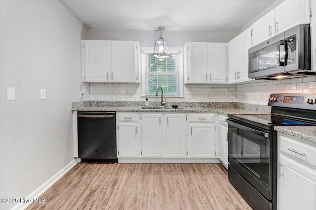 kitchen featuring white cabinetry, sink, stainless steel appliances, and a textured ceiling