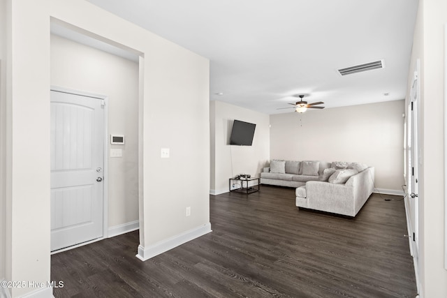 living room featuring ceiling fan and dark hardwood / wood-style flooring